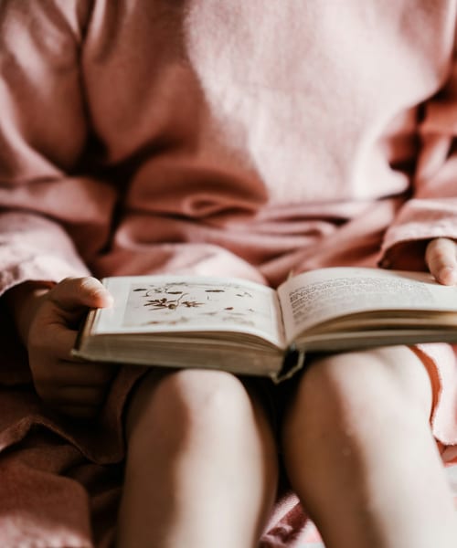 Woman reading a book — The Magic We Missed by Sarah Smith